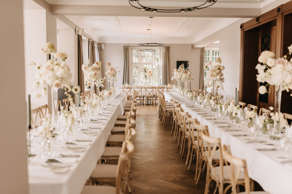 Innenbereich der Villa im Heinepark in Hamburg mit elegantem Dinner-Setup für eine exklusive Hochzeitsfeier. Hochwertige Ausstattung, stilvolle Tischgestaltung und besondere Atmosphäre für Heiraten an der Elbe. Professionelle Hochzeitsplanung von Sophia von Aspern für Paare aus Hamburg, Bremen, Hannover und Niedersachsen, realisiert von von Aspern Weddings.