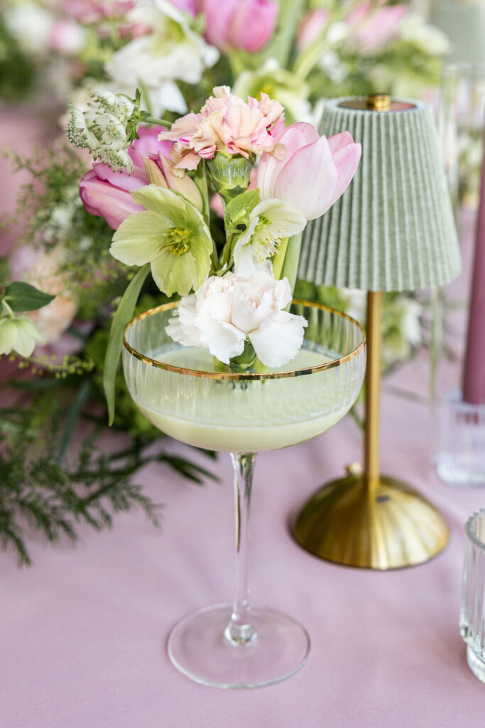 Floral dekoriertes Champagnerglas mit grüner Flüssigkeit, detailreiche Hochzeitsdeko und besonderer Champagnerturm Hochzeit Moment als stilvolles Highlight bei moderner Hochzeitsplanung in Hamburg, Bremen, Hannover und Niedersachsen von Aspern Weddings Sophia von Aspern